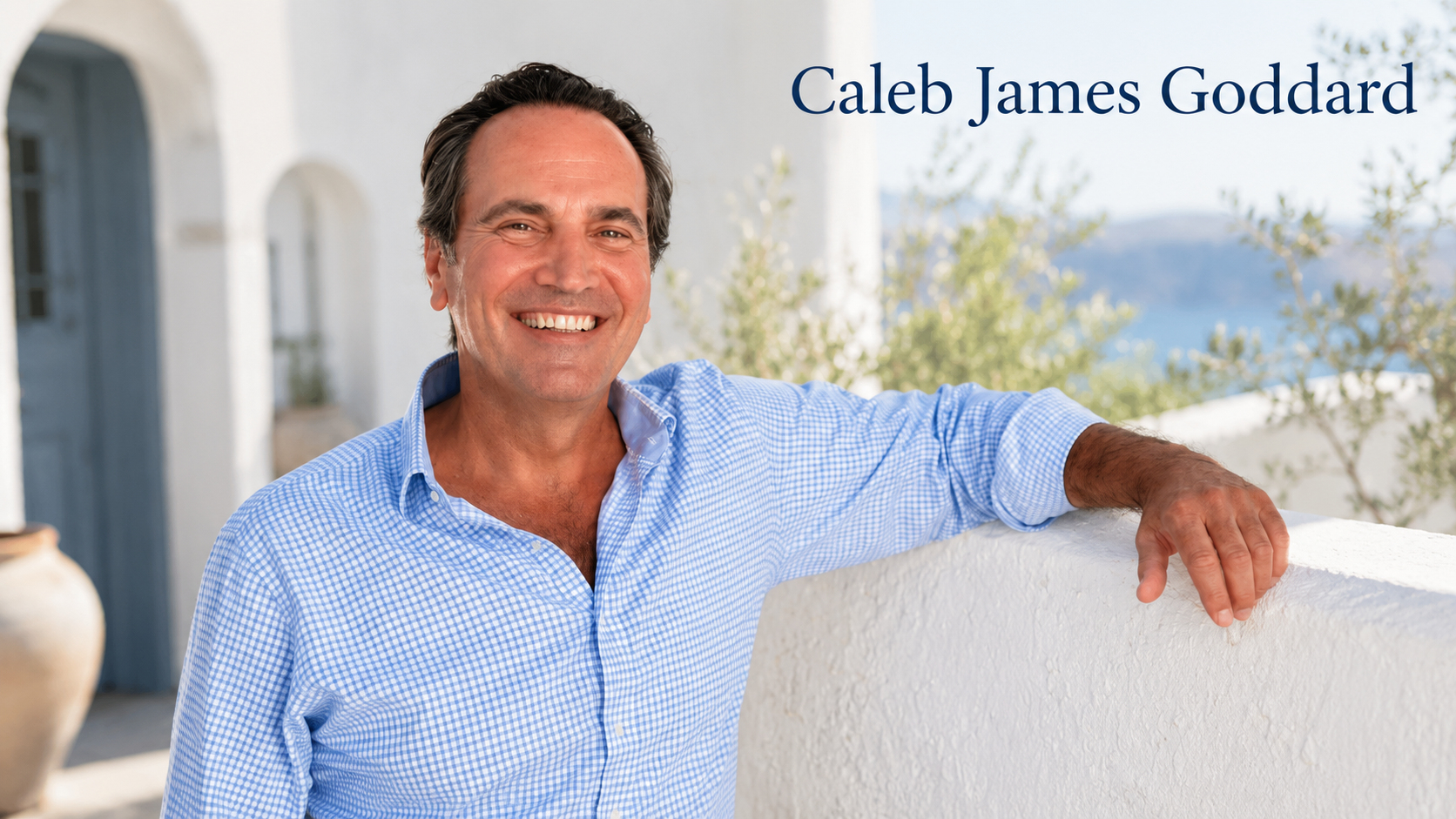 Caleb James Goddard smiling in a blue shirt against a bright Mediterranean background