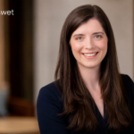 Amy Corenswet professional portrait in a modern office setting