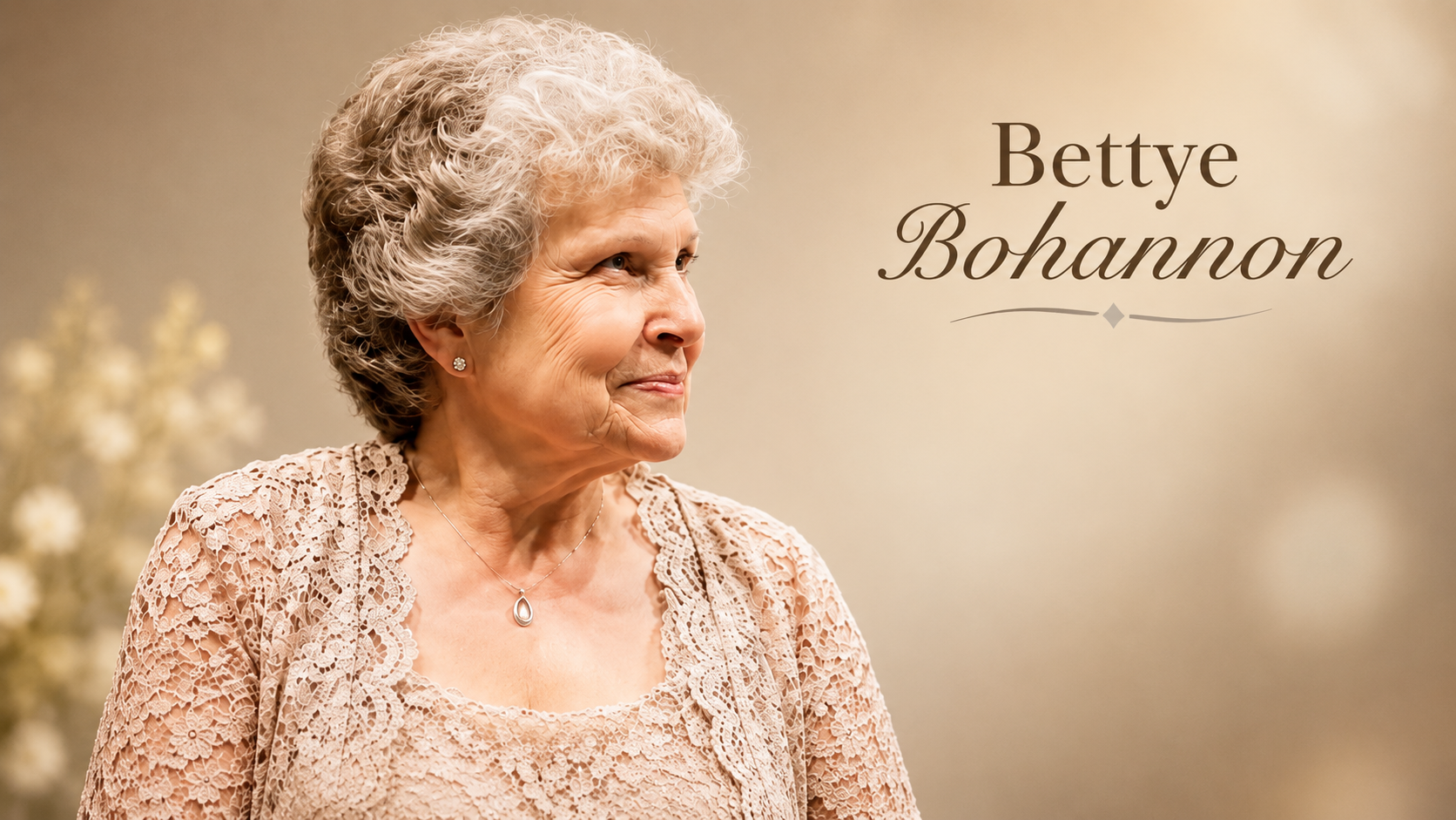 Bettye Bohannon in an elegant lace outfit against a warm background
