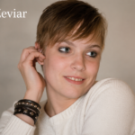 Loesha Zeviar wearing a white sweater in a professional portrait