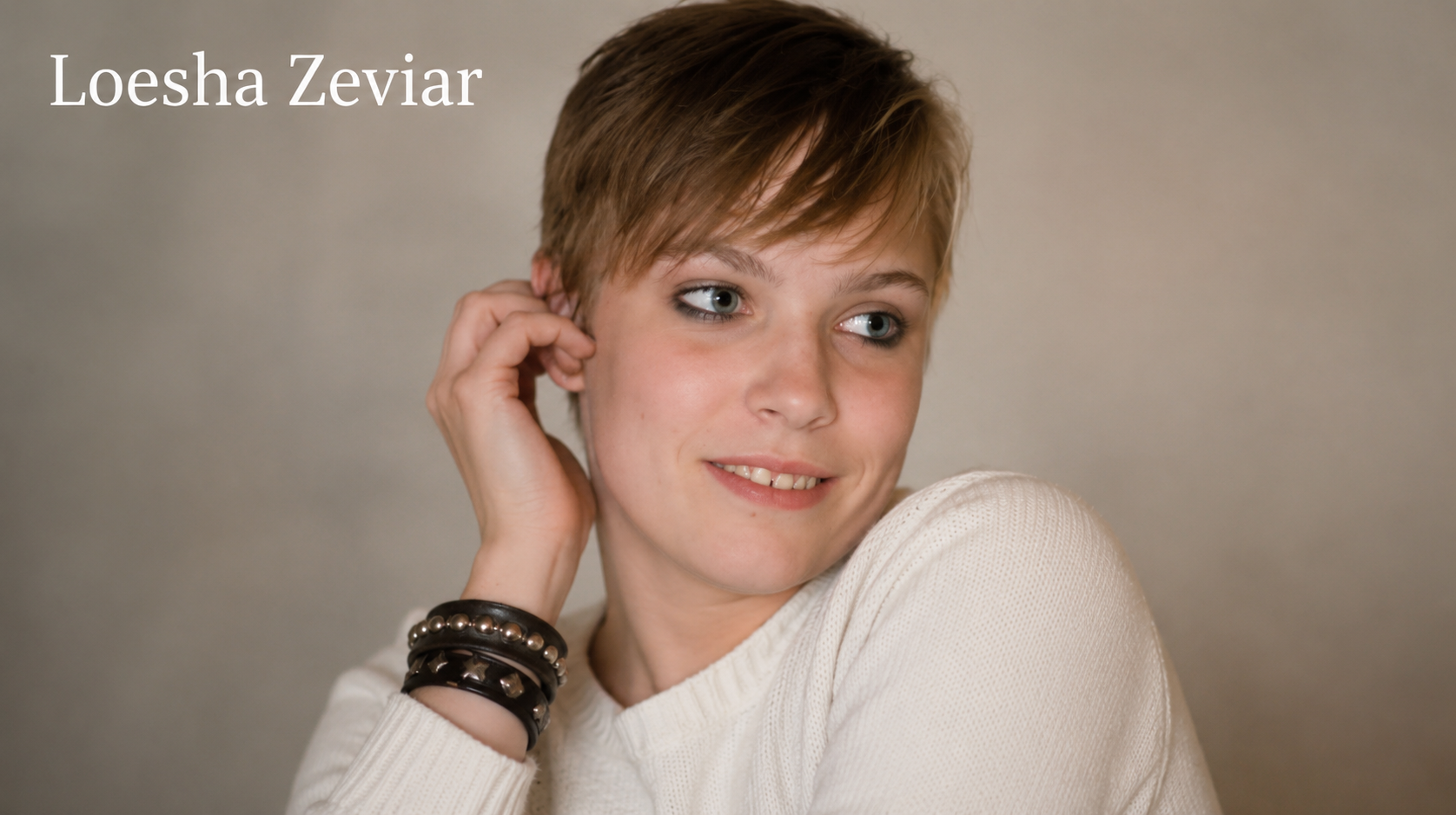 Loesha Zeviar wearing a white sweater in a professional portrait