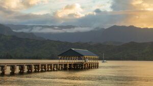 Hanalei Bay pier on Kauai’s North Shore with green mountains behind